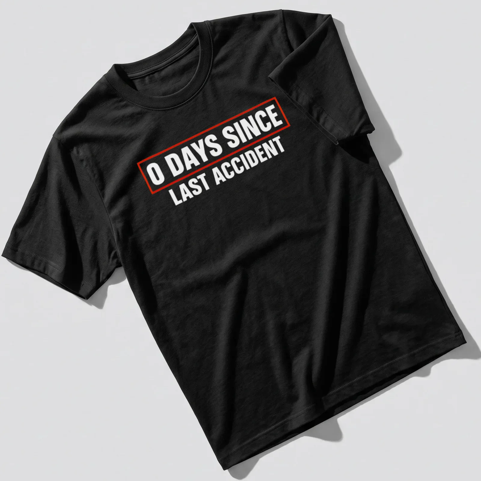 Humorous quote shirt with bold text stating '0 Days Since Last Accident' in red and white. — printed on a unisex t-shirt