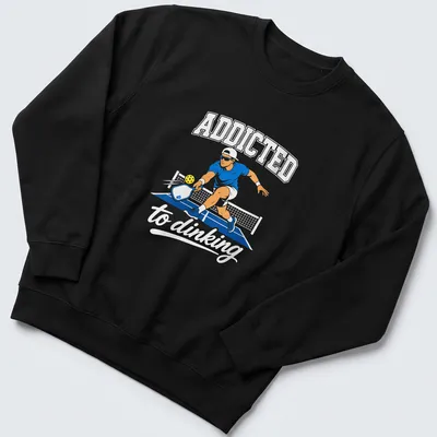 Vector illustration of a pickleball player with text Addicted to Dinking — printed on a unisex sweatshirt