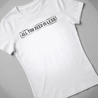 Bold distressed motivational quote t-shirt stating 'All You Need Is Less' in black, white, and red. — printed on a women's shirt