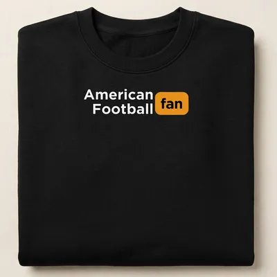 Bold typography t-shirt with American Football fan text in black, orange, and white — printed on a unisex sweatshirt
