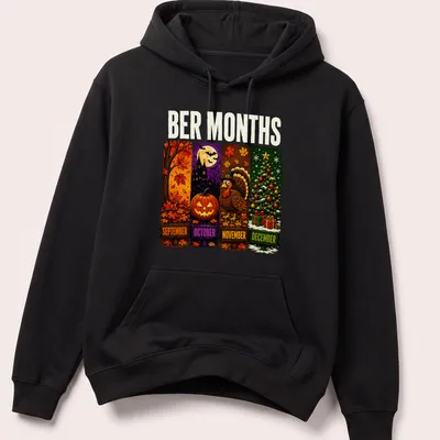 Colorful cartoon design featuring Halloween, Thanksgiving, and Christmas themes with the text 'BER MONTHS' — printed on a unisex hoodie