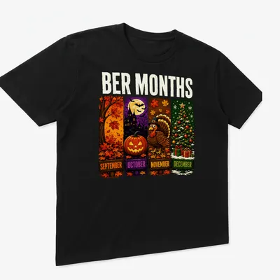 Colorful cartoon design featuring Halloween, Thanksgiving, and Christmas themes with the text 'BER MONTHS' — printed on a unisex t-shirt (angled view)