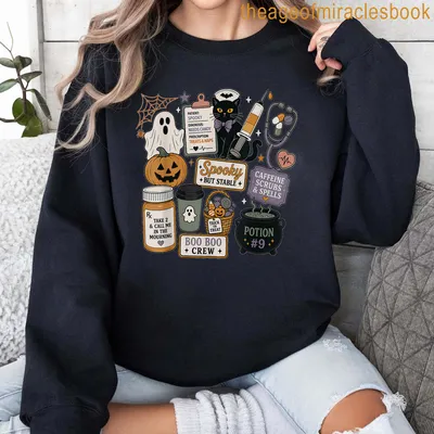 Kawaii doodle black cat Halloween shirt with colorful playful text — printed on a sweatshirt
