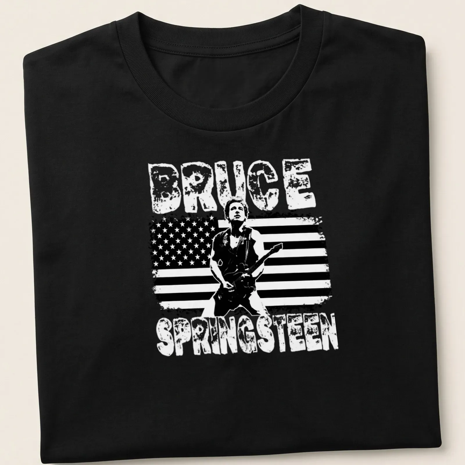 Vintage distressed Bruce Springsteen T-shirt with bold lettering and guitarist graphic — printed on a unisex t-shirt
