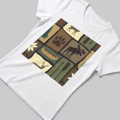 Patchwork illustration of a moose in a woodland setting with trees and a canoe — printed on a women's shirt