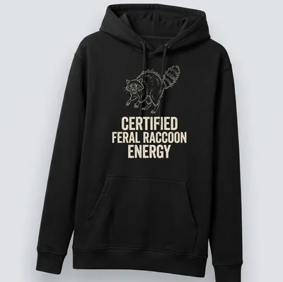 Line-art design of a feral raccoon with text declaring 'Certified Feral Raccoon Energy' — printed on a unisex hoodie