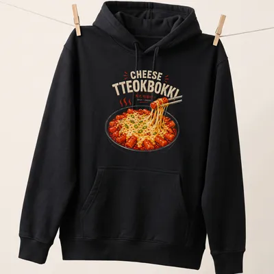 Illustrative shirt featuring colorful Korean Tteokbokki with text about spicy cheesy rice cakes — printed on a unisex hoodie