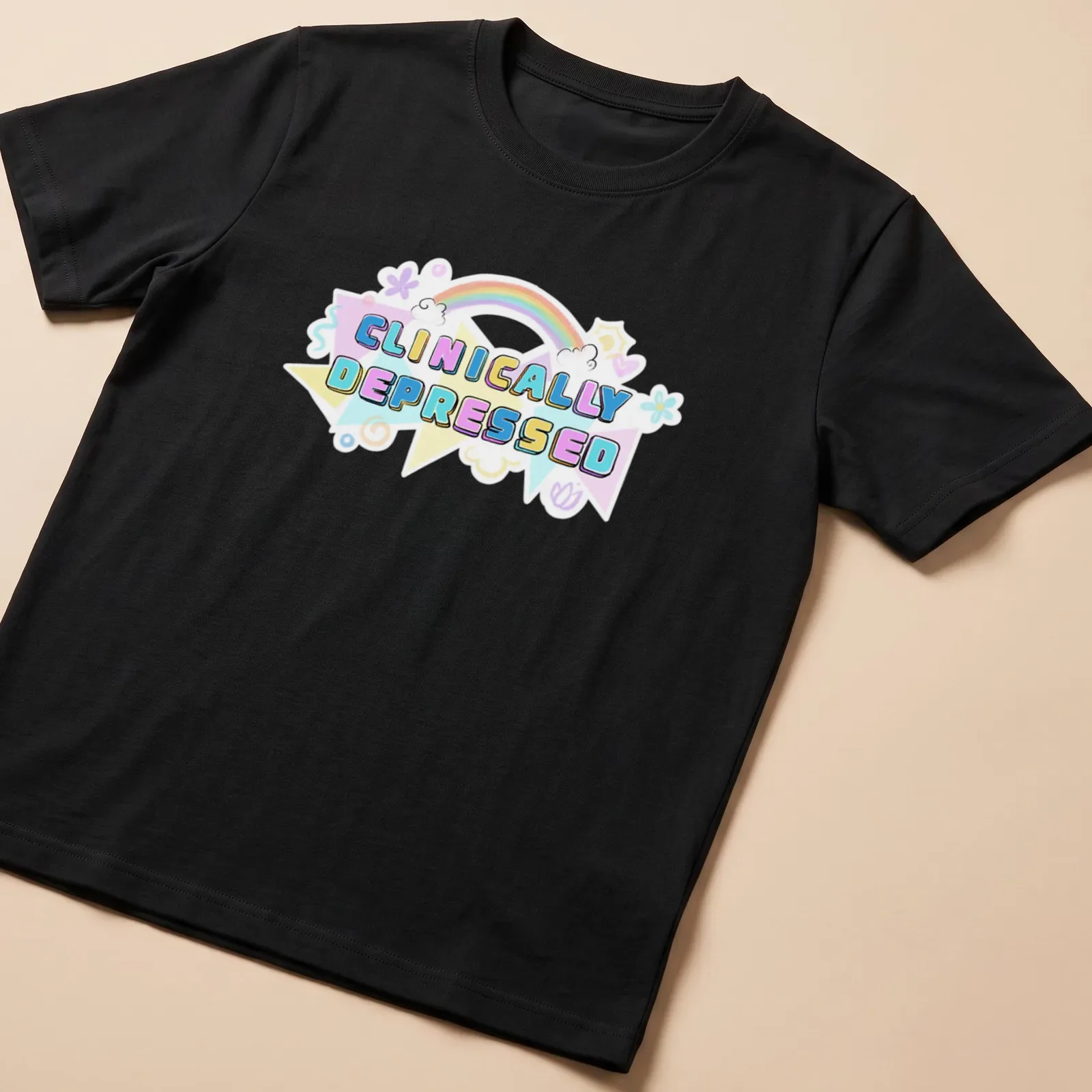 Kawaii T-shirt featuring rainbow design and the text 'CLINICALLY DEPRESSED' in pastel colors — printed on a unisex t-shirt