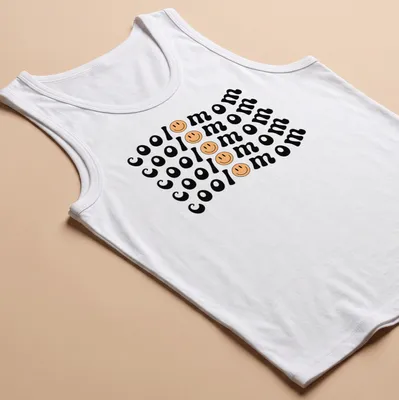 Bold playful Cool Mom T-shirt with smiley face graphic in black, yellow, and peach — printed on a tank top