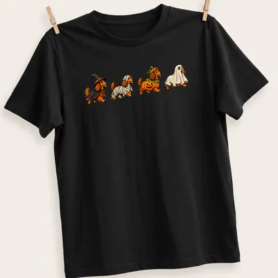 Colorful cartoon of Dachshund dogs in Halloween costumes — printed on a unisex t-shirt