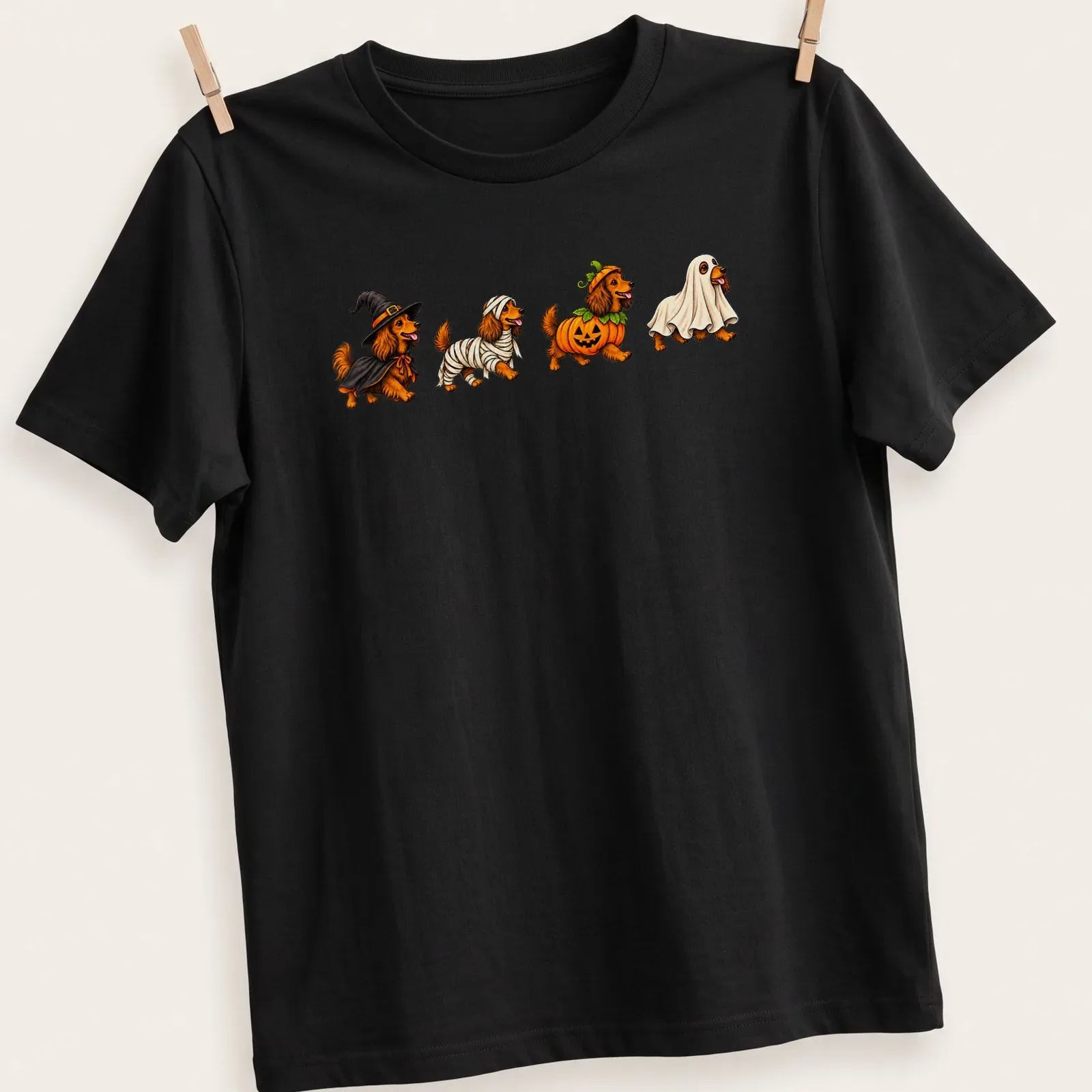 Colorful cartoon of Dachshund dogs in Halloween costumes — printed on a unisex t-shirt