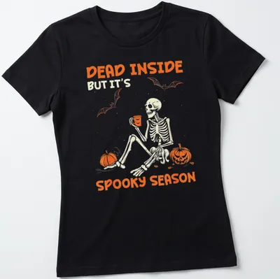 A playful skeleton surrounded by pumpkins with Halloween-themed text — printed on a women's shirt