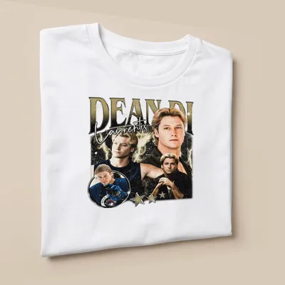 Vintage collage t-shirt featuring Dean Di Laurentis in gold, black, white, and blue — printed on a unisex t-shirt (angled view)