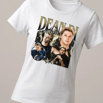 Vintage collage t-shirt featuring Dean Di Laurentis in gold, black, white, and blue — printed on a women's shirt