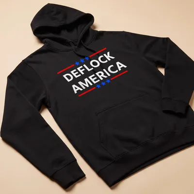 Bold patriotic design featuring the phrase DEFLOCK AMERICA in red, blue, and white. — printed on a unisex hoodie
