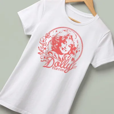 Minimalistic portrait of Dolly Parton with flowers in soft pink and white — printed on a women's shirt