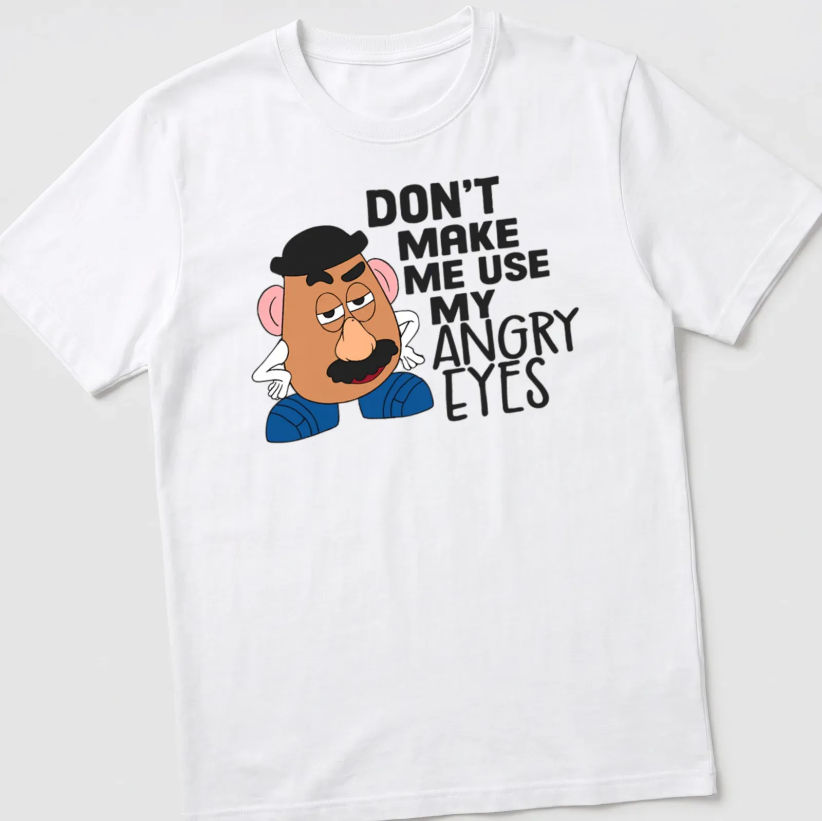 Cartoon potato character with angry eyes and humorous text. — printed on a unisex t-shirt
