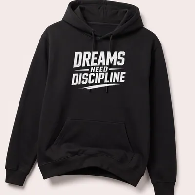 Bold typography t-shirt with the phrase Dreams Need Discipline over a mountain design — printed on a unisex hoodie