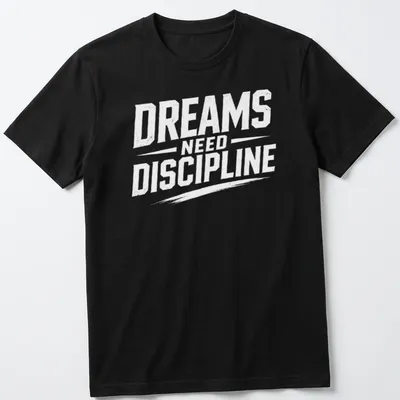 Bold typography t-shirt with the phrase Dreams Need Discipline over a mountain design