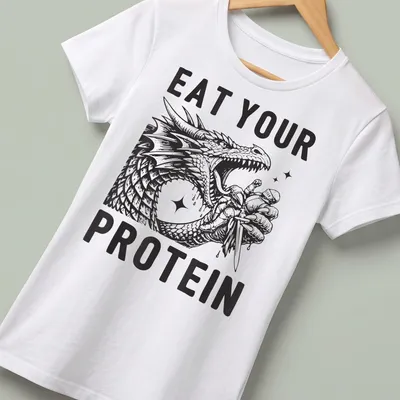 Bold illustration of a dragon flexing with the text Eat Your Protein — printed on a women's shirt