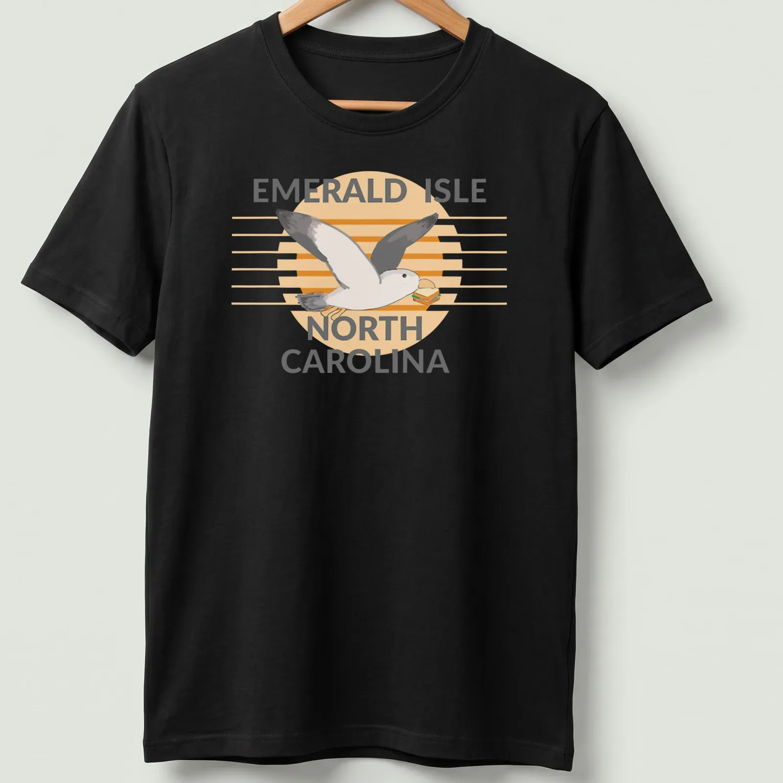 Illustrative design featuring a seagull carrying a sandwich with the text Emerald Isle North Carolina — printed on a unisex t-shirt