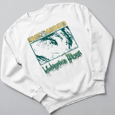 Distressed graphic of a wolverine with gold and teal lettering on a t-shirt. — printed on a unisex sweatshirt