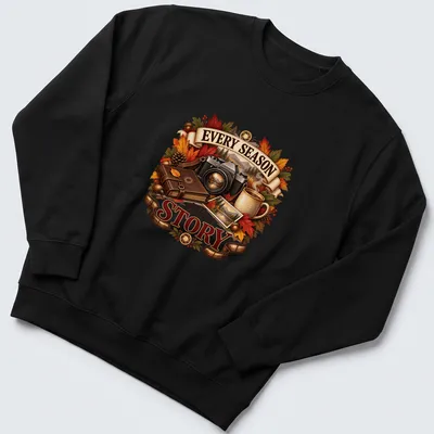 Detailed illustration of autumn leaves, a camera, and a coffee mug around the phrase Every Season tells a Story — printed on a unisex sweatshirt