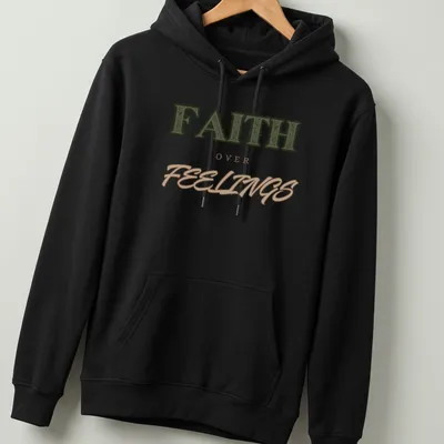 Bold vintage print of 'FAITH over FEELINGS' in green, brown, and tan typography — printed on a unisex hoodie