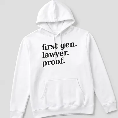 Bold typography t-shirt celebrating first-generation lawyers with black text on white background — printed on a unisex hoodie