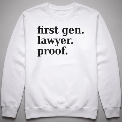Bold typography t-shirt celebrating first-generation lawyers with black text on white background — printed on a unisex sweatshirt