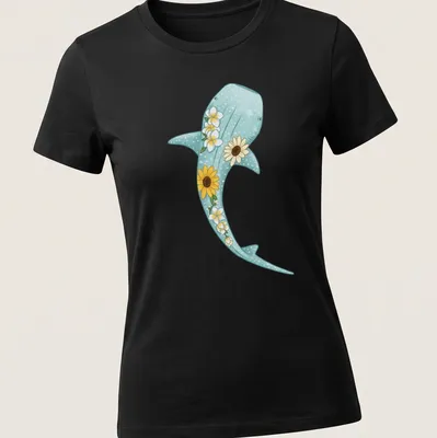 Kawaii illustration of a whale shark surrounded by sunflowers and plumerias in light blue and yellow — printed on a women's shirt