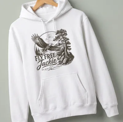 Vintage eagle graphic with text reading 'FLY FREE, Jackie BIG BEAR LAKE, CALIFORNIA' in black, white, and gray — printed on a unisex hoodie