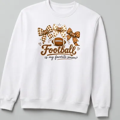 Whimsical design of footballs and bows with the text 'Football is my favorite season' — printed on a unisex sweatshirt