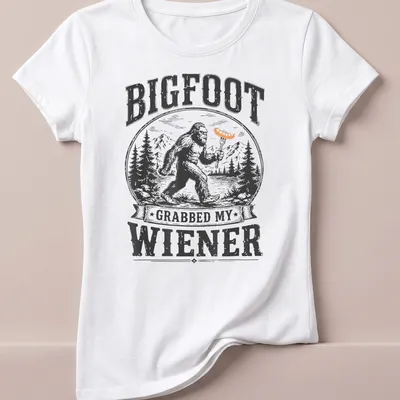 Vintage woodcut print of Bigfoot with humorous text about a wiener — printed on a women's shirt