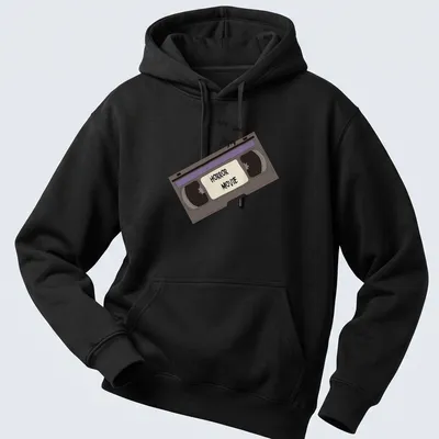 Cartoon-style shirt with a VHS tape and bats, featuring bold 'HORROR MOVIE' text. — printed on a unisex hoodie