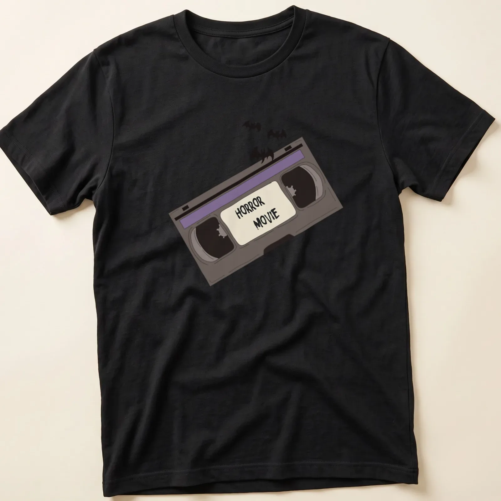 Cartoon-style shirt with a VHS tape and bats, featuring bold 'HORROR MOVIE' text. — printed on a unisex t-shirt