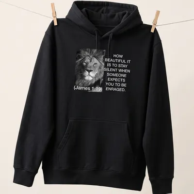 Black and white lion photo with text about silence and restraint — printed on a unisex hoodie