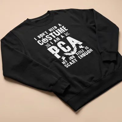 Funny Halloween t-shirt with bold text I Don't Need A Costume I Am A PCA — printed on a unisex sweatshirt