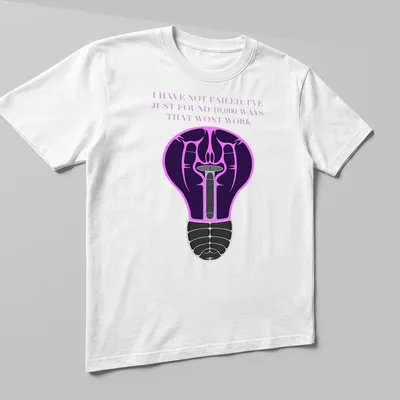 Illustration of a light bulb with motivational text in purple, black, pink, and white — printed on a unisex t-shirt (angled view)