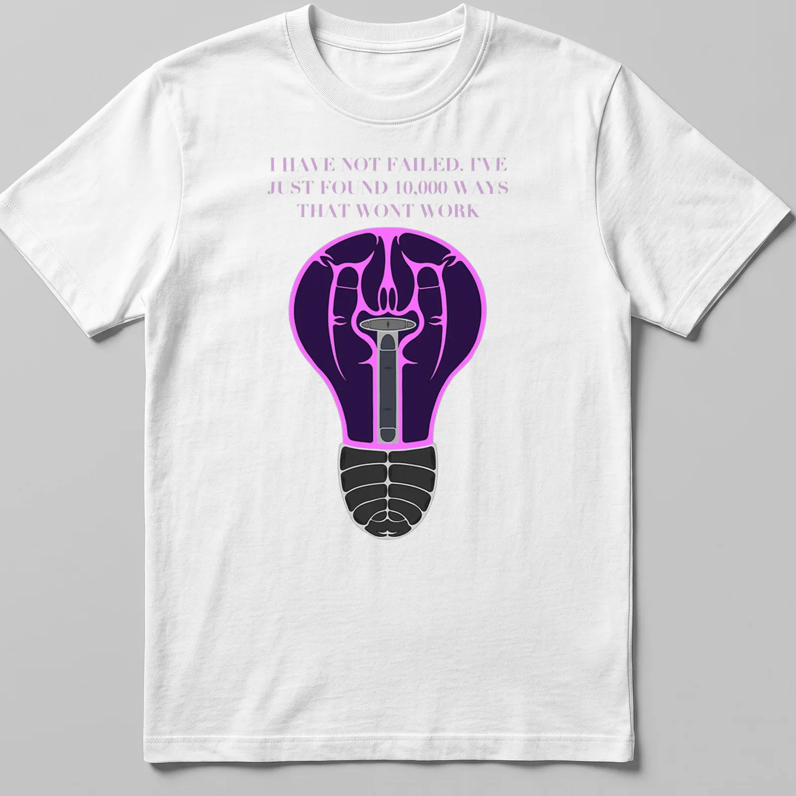 Illustration of a light bulb with motivational text in purple, black, pink, and white — printed on a unisex t-shirt
