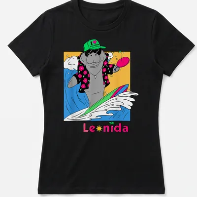 Cartoon manatee surfing with colorful waves under the text I ❤️ VACATION Leonida — printed on a women's shirt