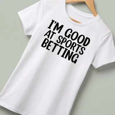 T-shirt with bold black and white typography stating I'm Good At Sports Betting — printed on a women's shirt