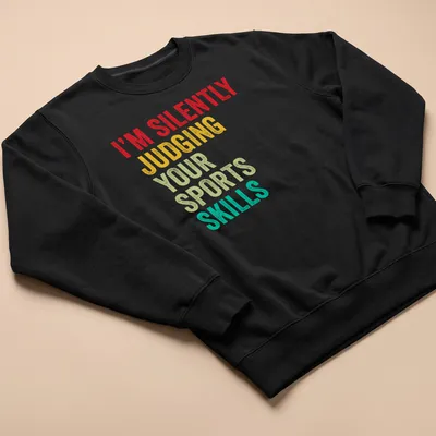 Colorful typography design stating 'I'm Silently Judging Your Sports Skills' in bold letters. — printed on a unisex sweatshirt
