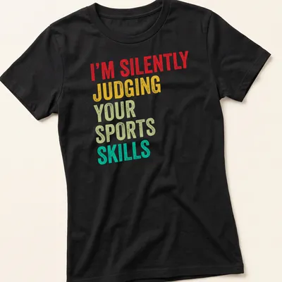 Colorful typography design stating 'I'm Silently Judging Your Sports Skills' in bold letters. — printed on a women's shirt