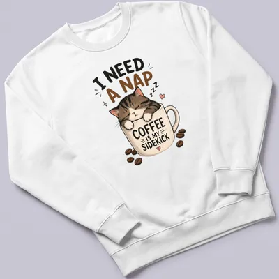 Kawaii illustration of a sleepy cat with coffee-themed text about naps. — printed on a unisex sweatshirt