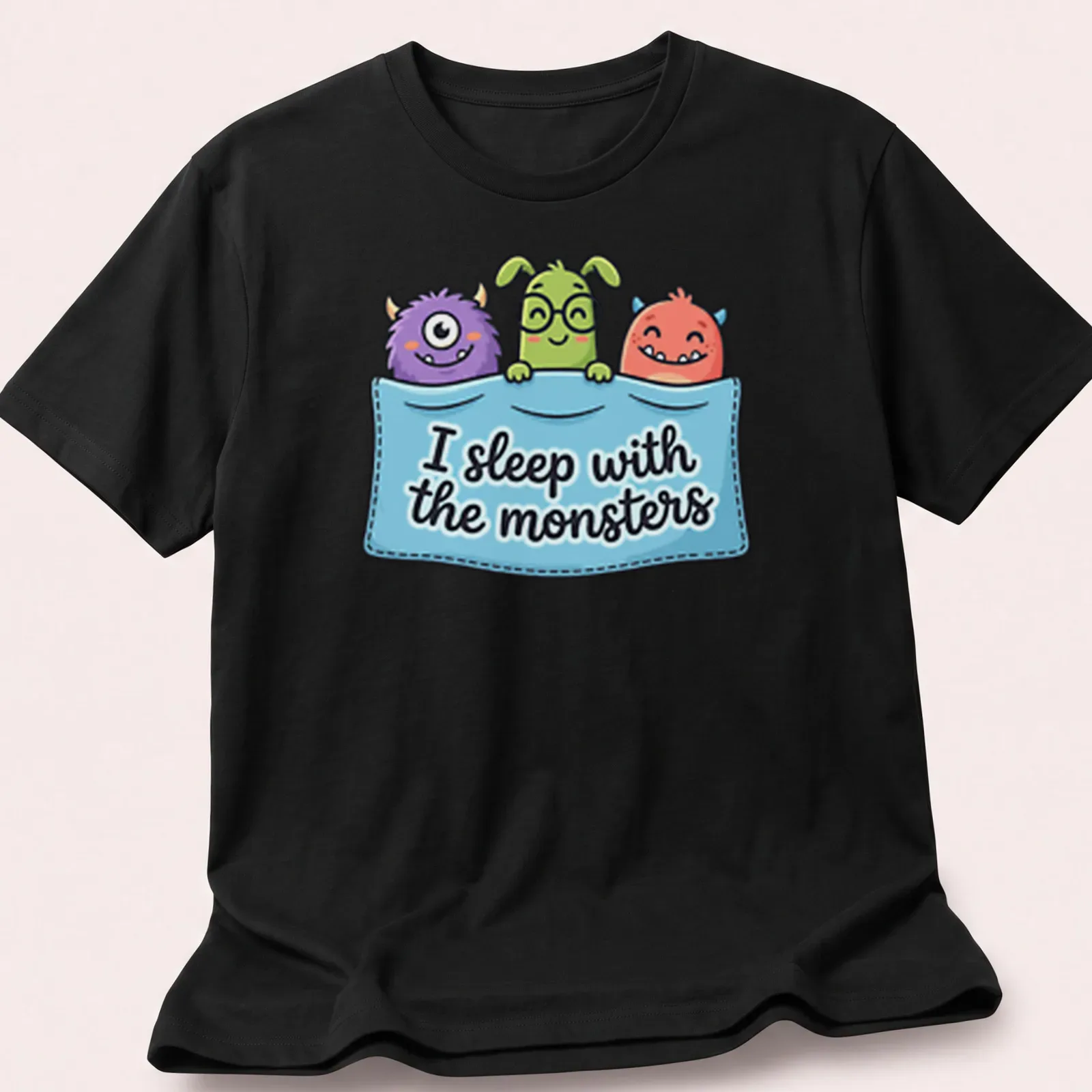 Kawaii cartoon monsters with the phrase I sleep with the monsters in bright colors. — printed on a unisex t-shirt