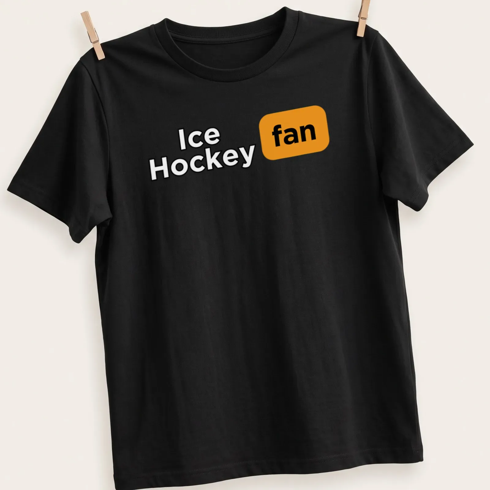 Bold typography Ice Hockey fan t-shirt in black, orange, and white colors — printed on a unisex t-shirt