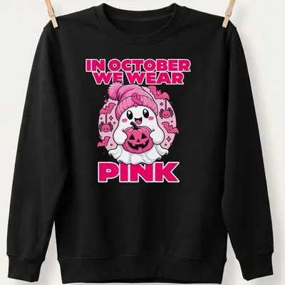 Kawaii ghost holding a pumpkin with the text 'In October We Wear Pink' — printed on a unisex sweatshirt