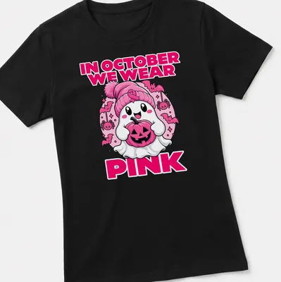 Kawaii ghost holding a pumpkin with the text 'In October We Wear Pink' — printed on a women's shirt