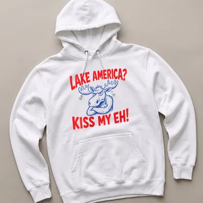 Cartoon moose graphic with the text 'Lake America? Kiss My Eh!' in red, blue, and white — printed on a unisex hoodie